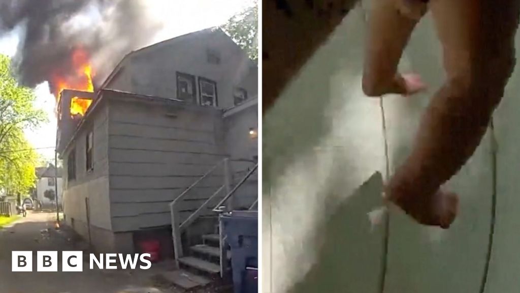 Police officer catches baby dropped from window of burning home